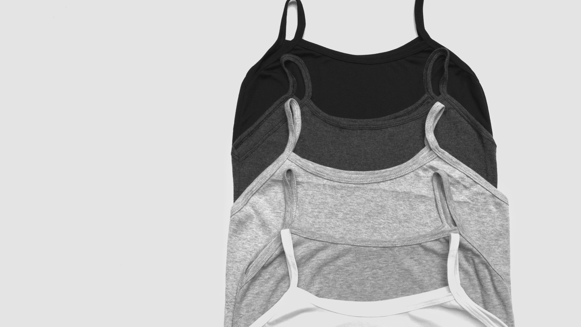 grayscale photos of five camisoles