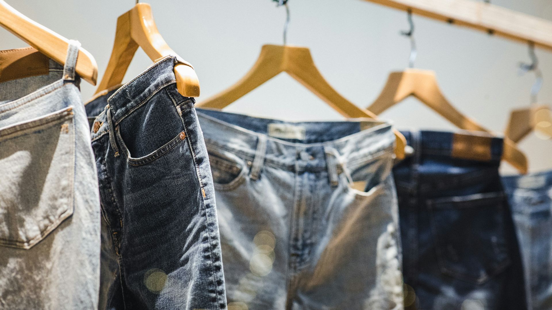 selective focus photography of hanged denim jeans