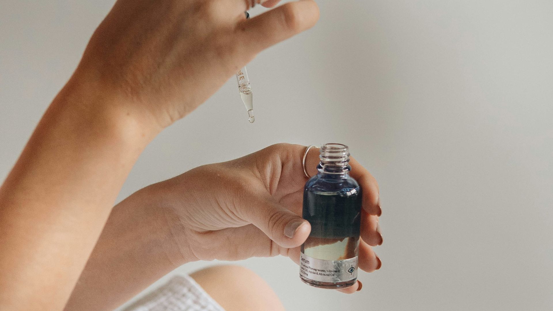 person holding black glass bottle