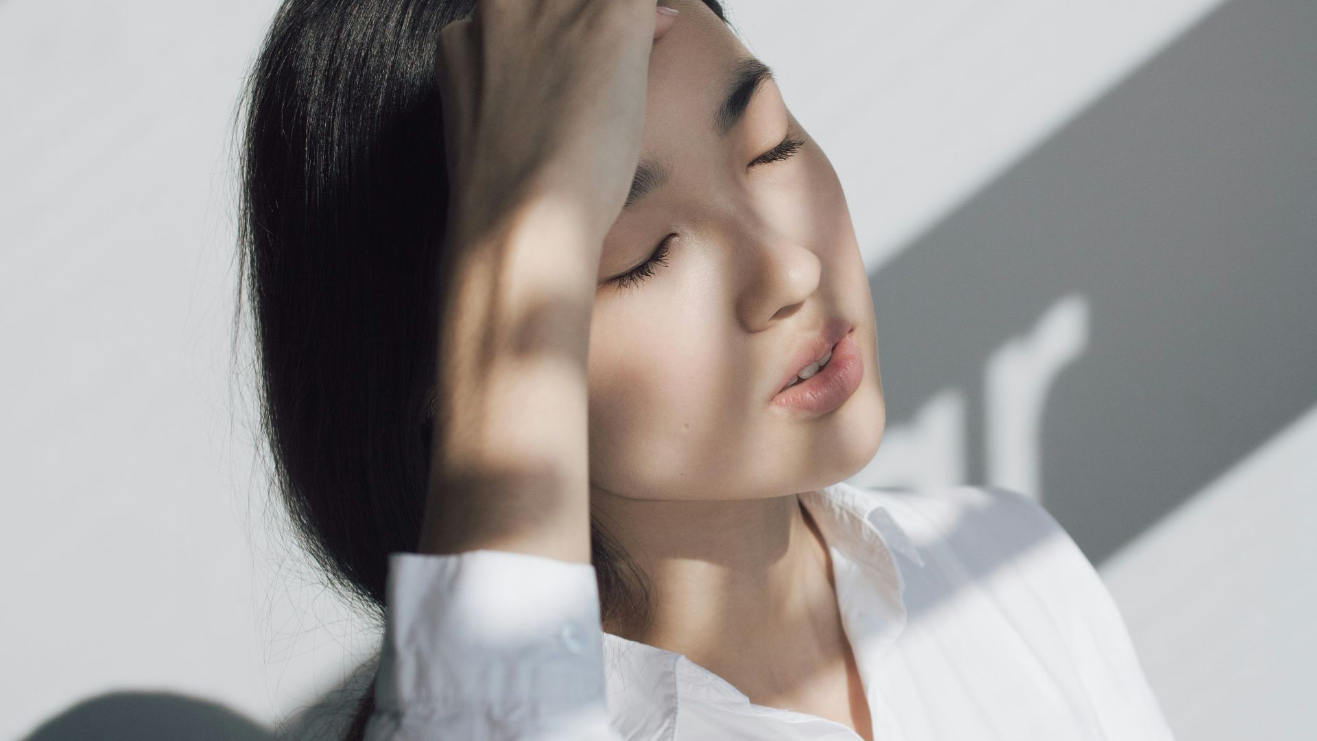 woman leaning on white table