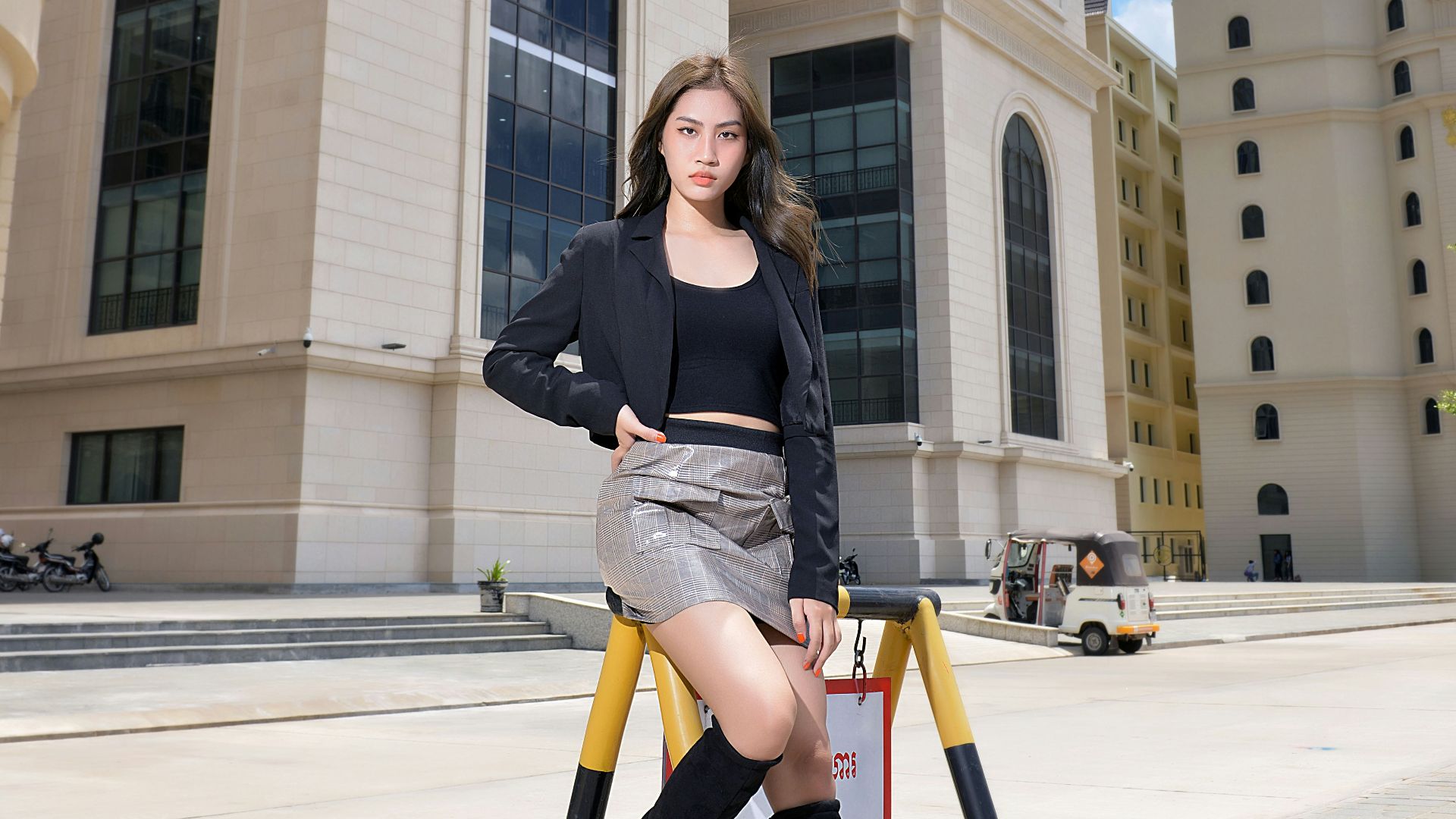 woman in black long sleeve shirt and yellow pants sitting on brown wooden chair