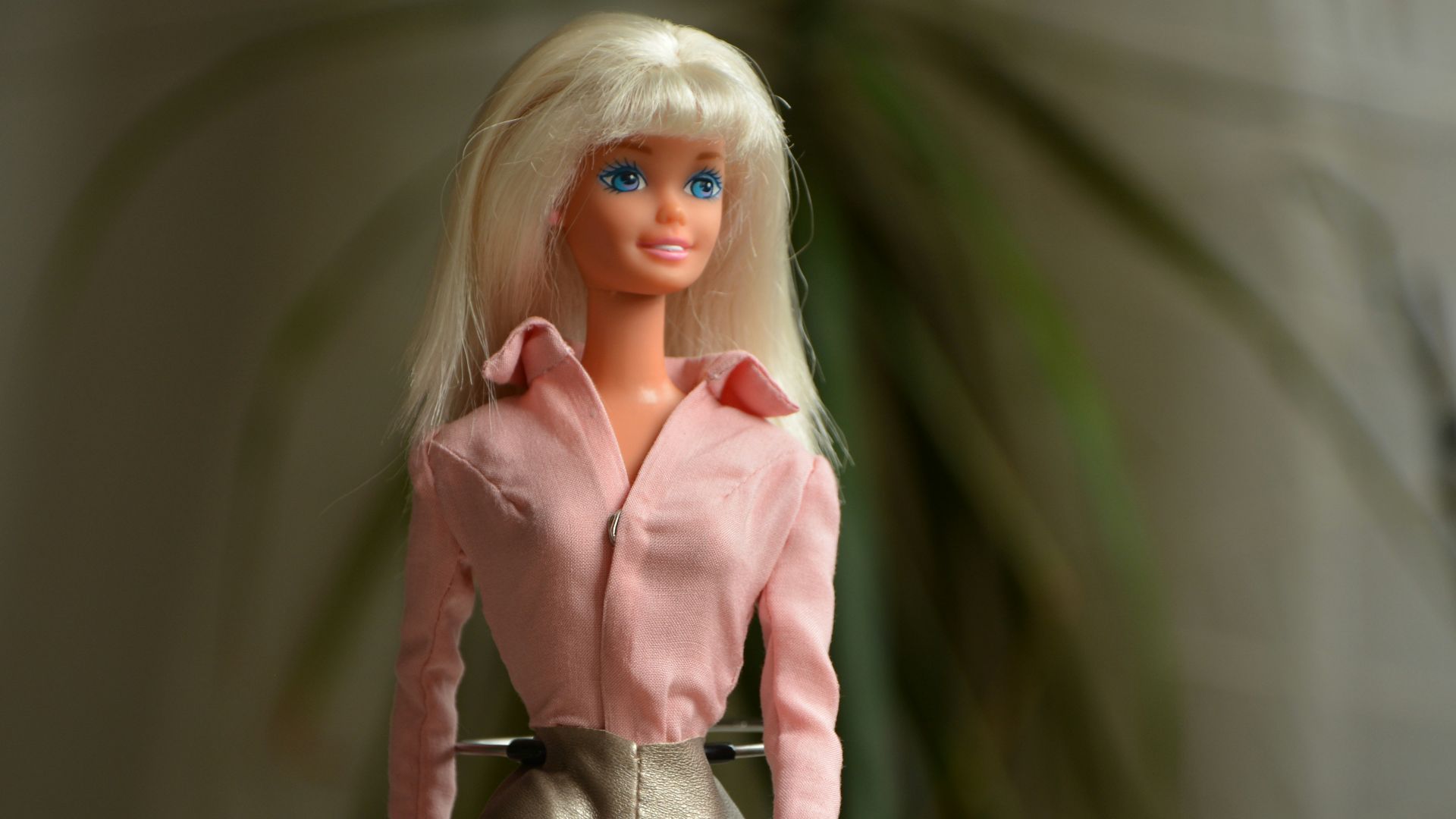 woman in pink dress shirt and gray pants