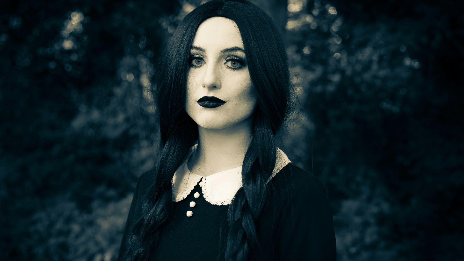 a woman with long black hair and black lipstick