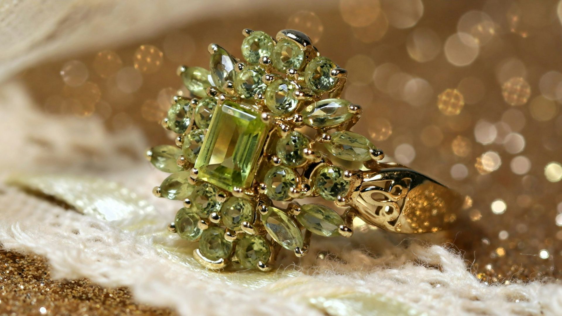 silver diamond studded ring on white textile