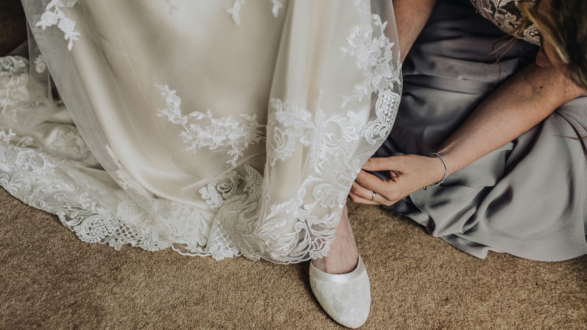woman fixing shoes of another woman