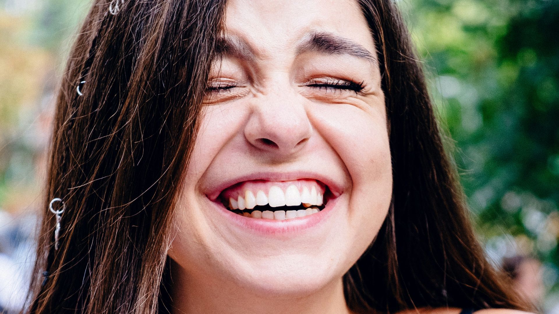 woman in black spaghetti strap top smiling