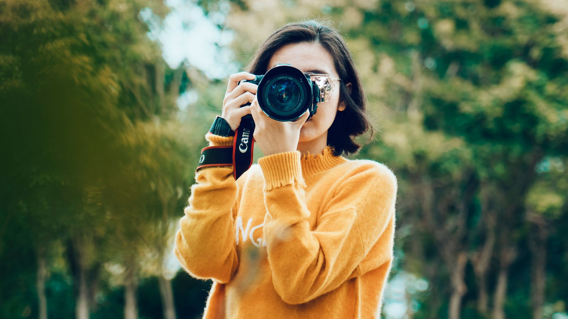 woman holding DSLR camera