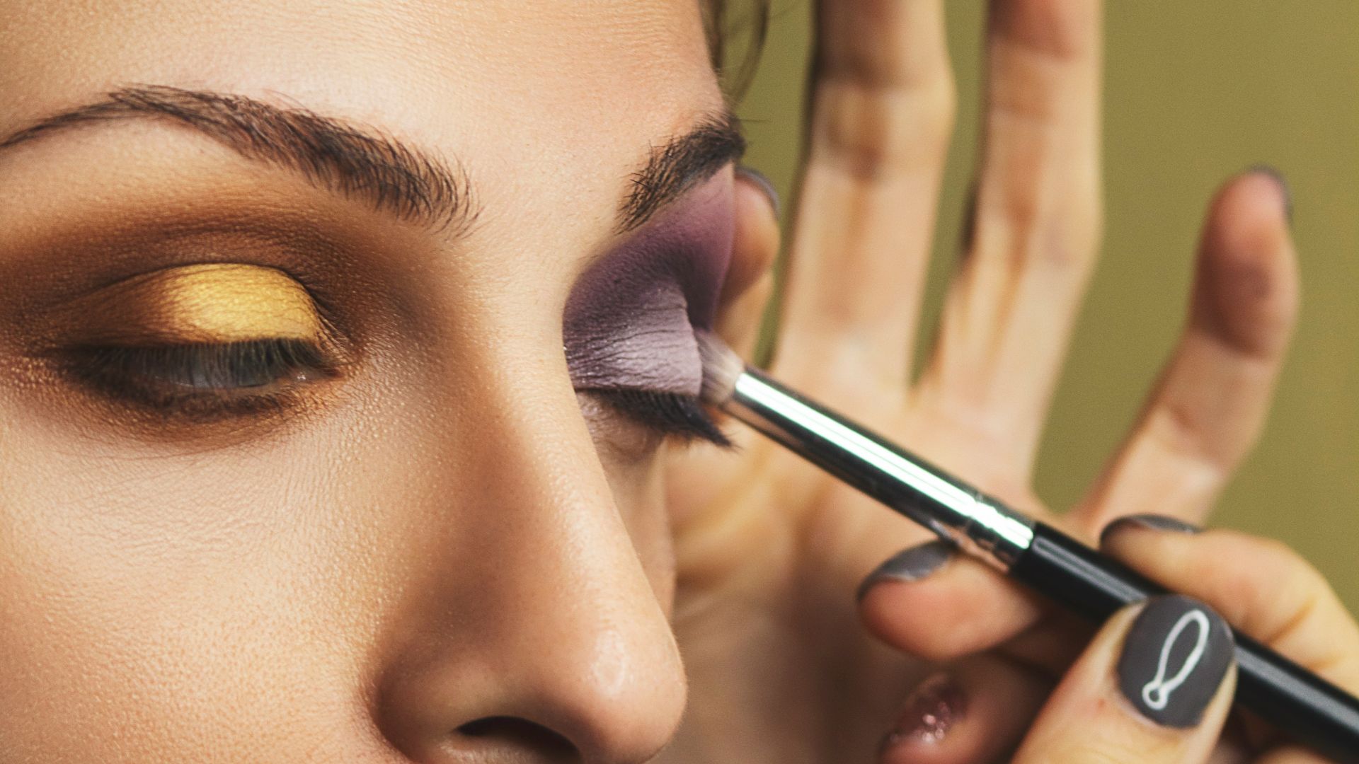 woman with pink lipstick holding black pen