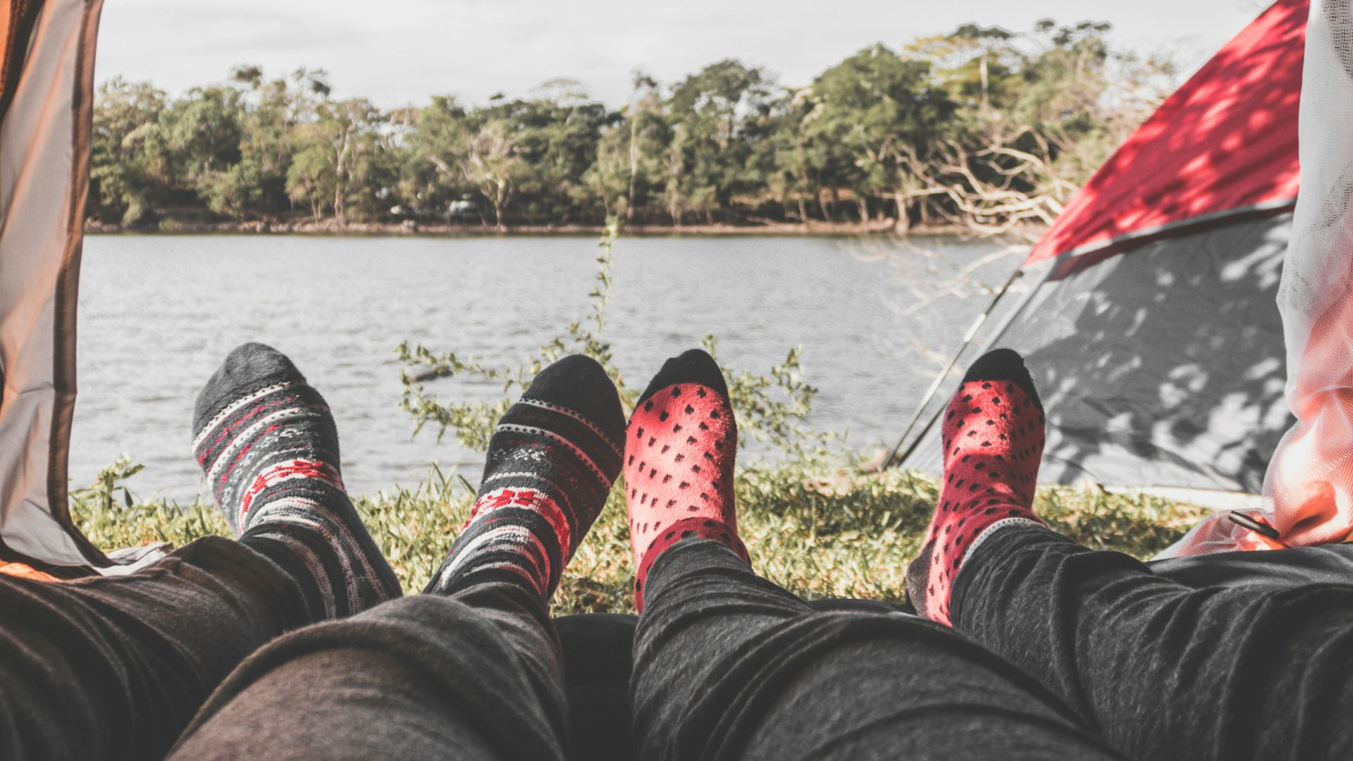 two person laying inside tent