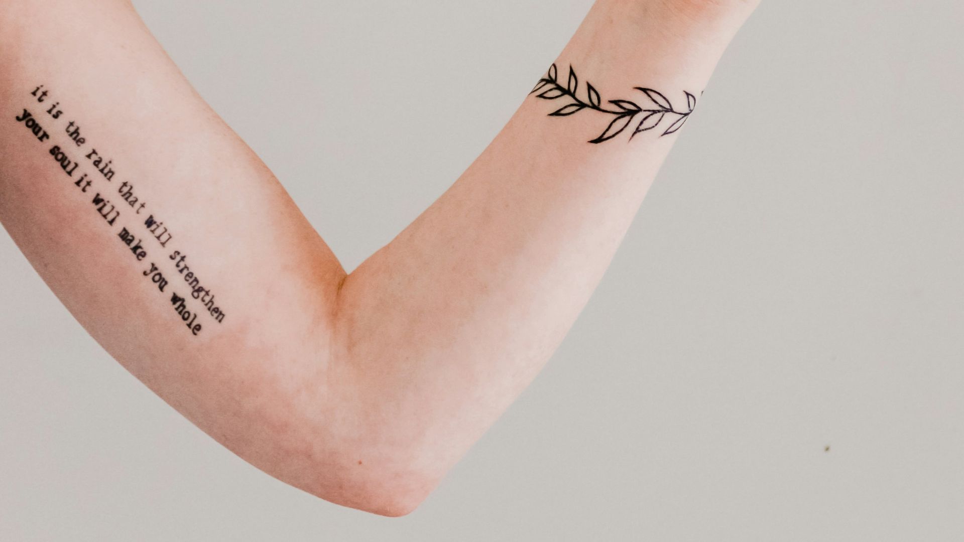 person showing arm and wrist tattoo