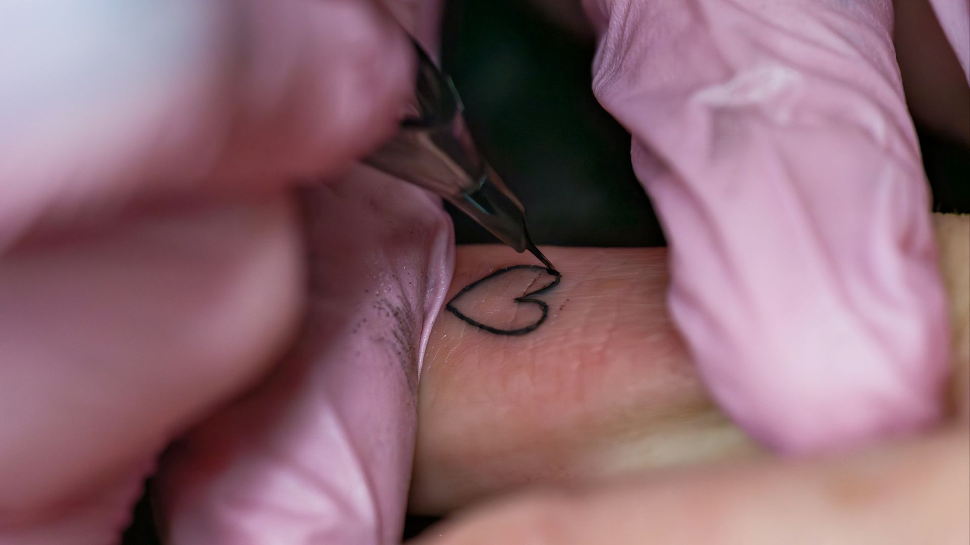 A woman getting a tattoo on her arm