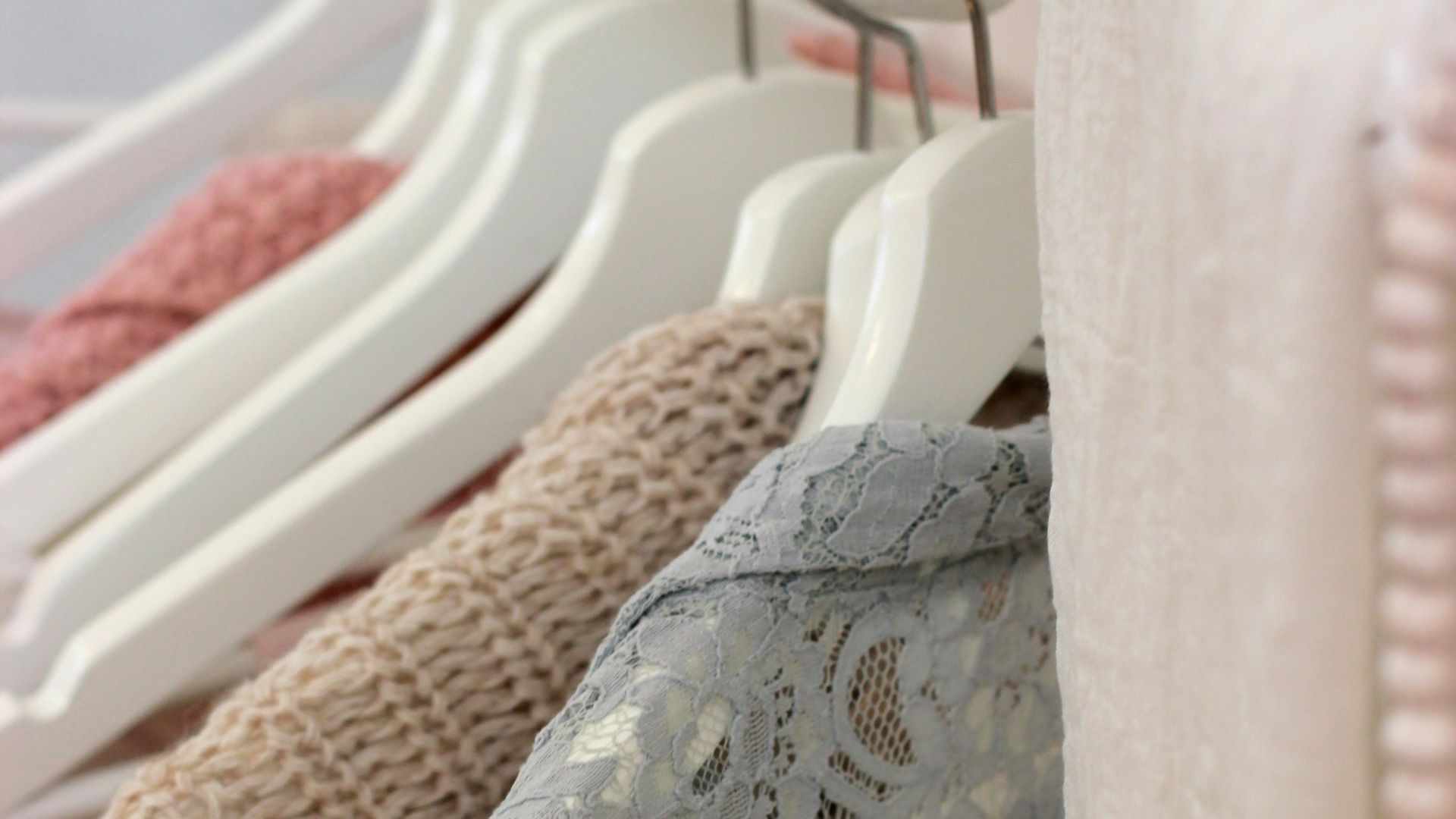 clothes hanging on white rack