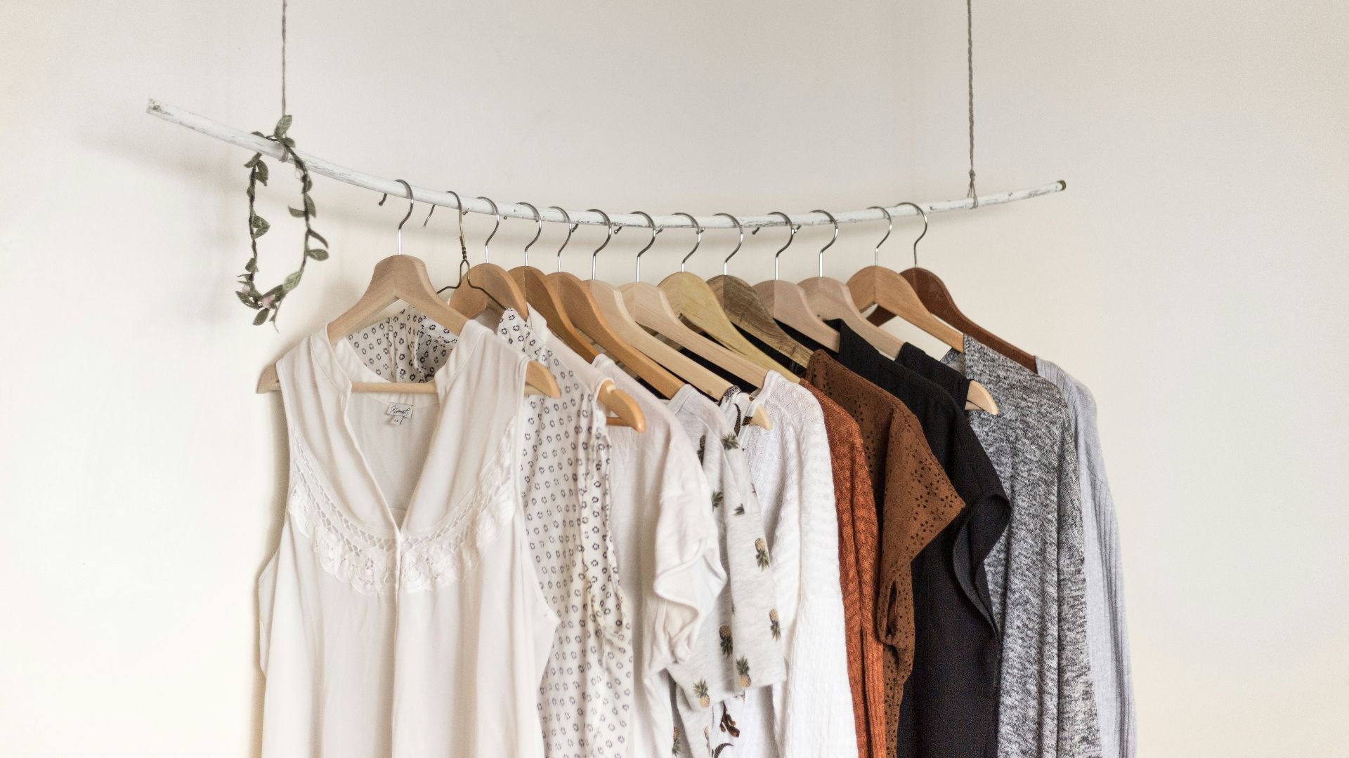 assorted clothes in wooden hangers