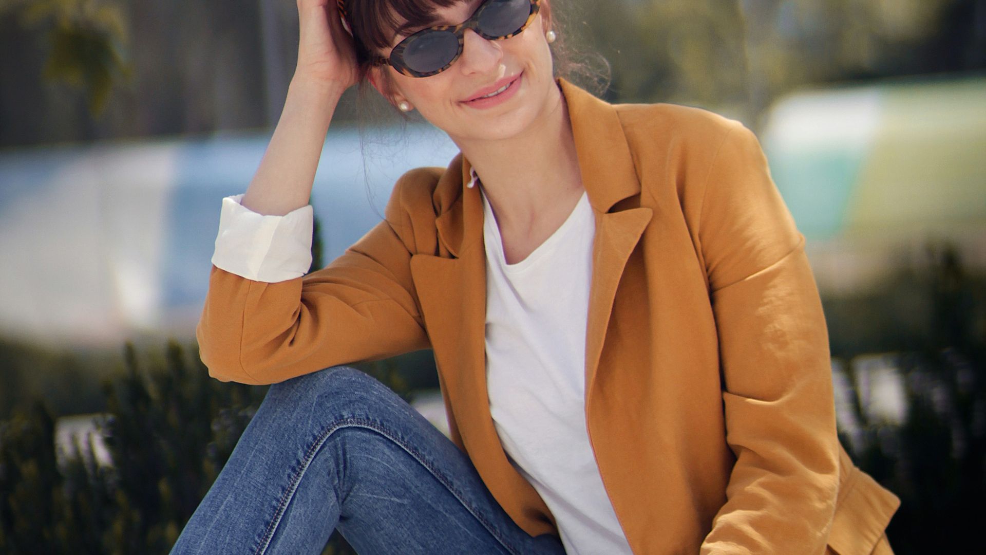 woman sitting on concrete bench near tree