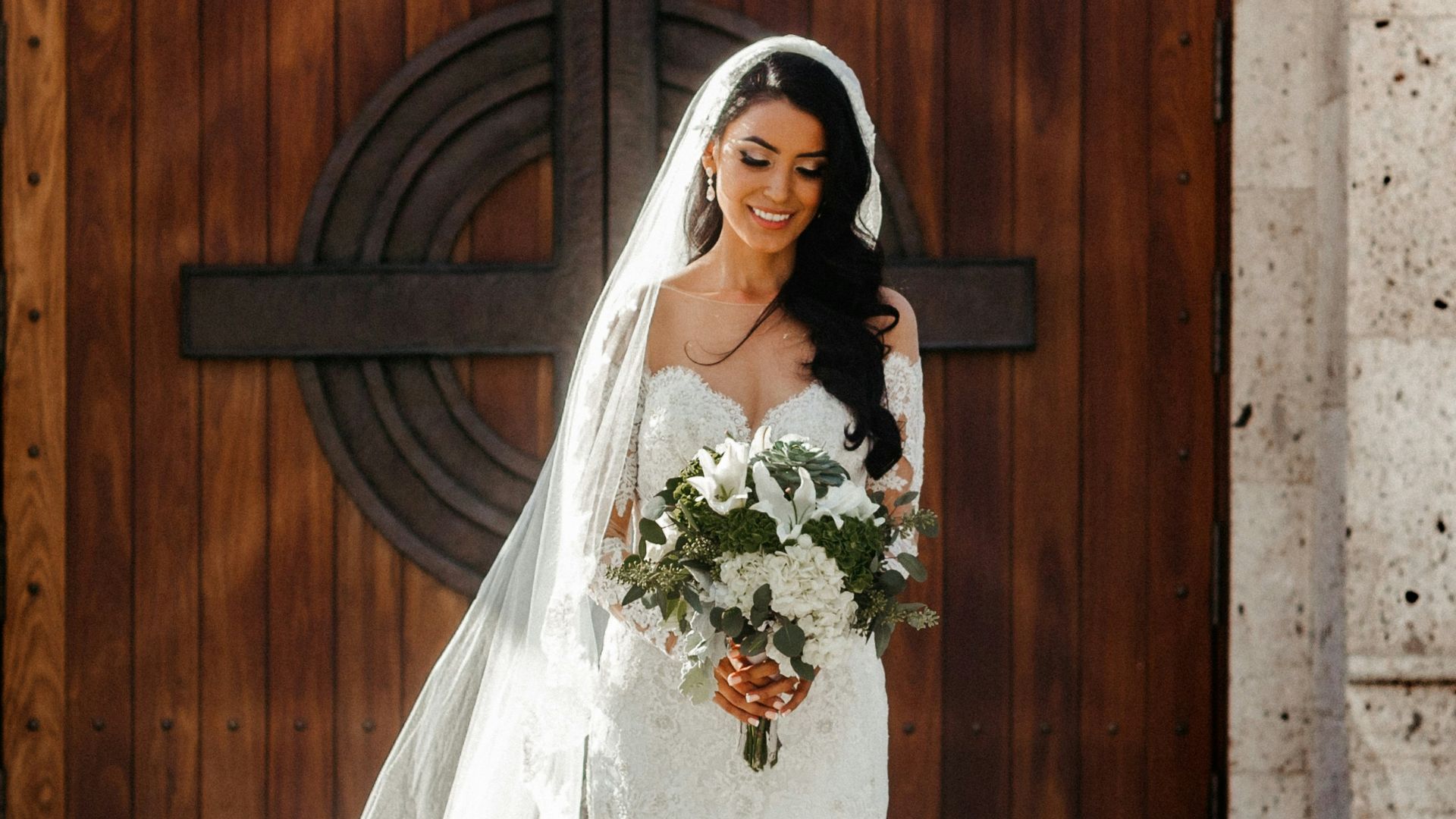 woman wearing wedding dress holding bouquet of flowers