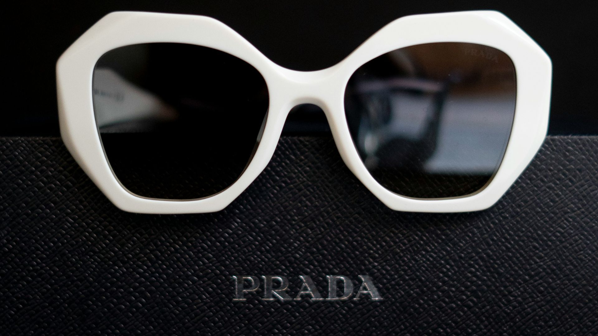 A pair of sunglasses sitting on top of a book