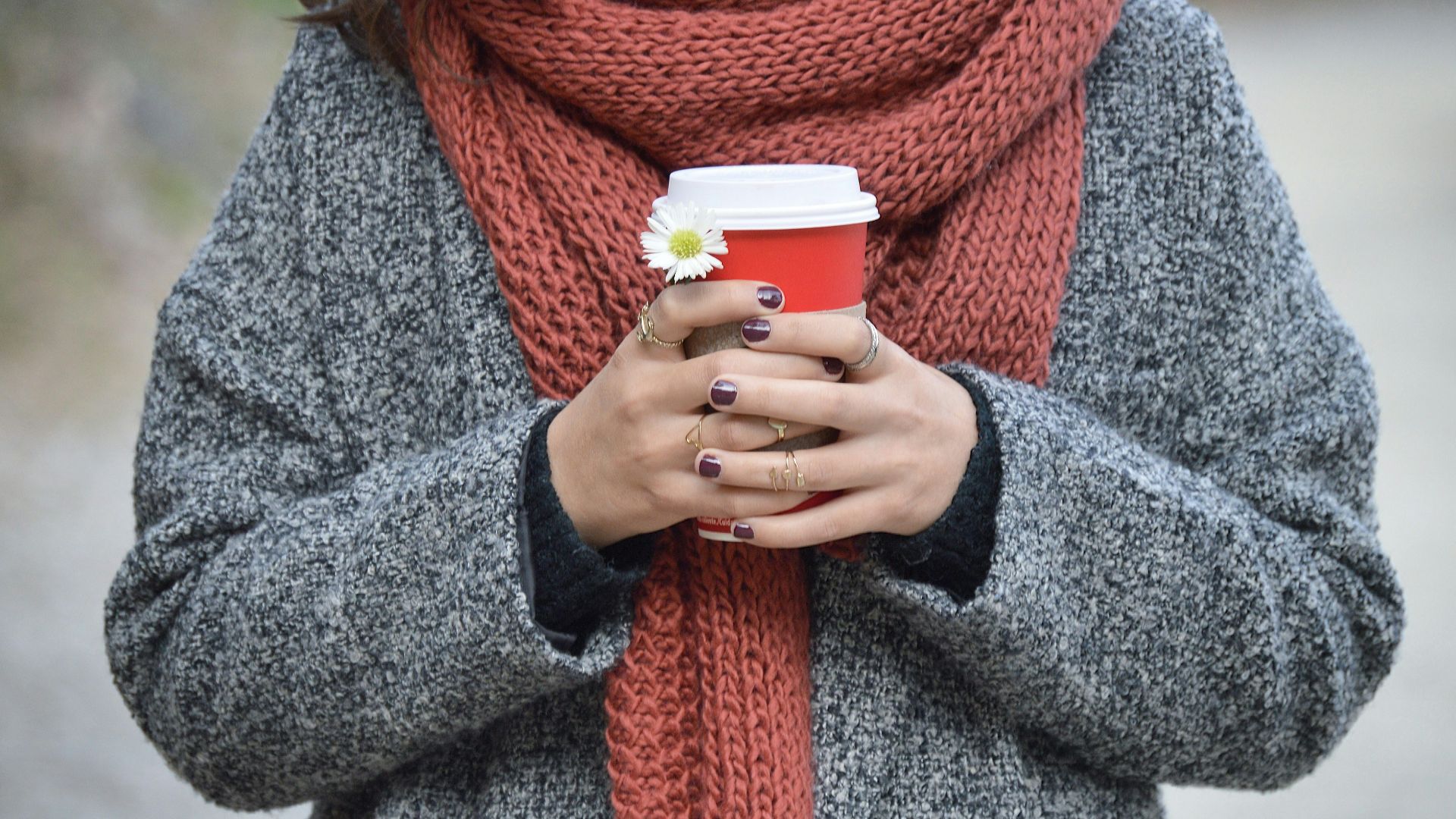 person holding red and white disposable cup