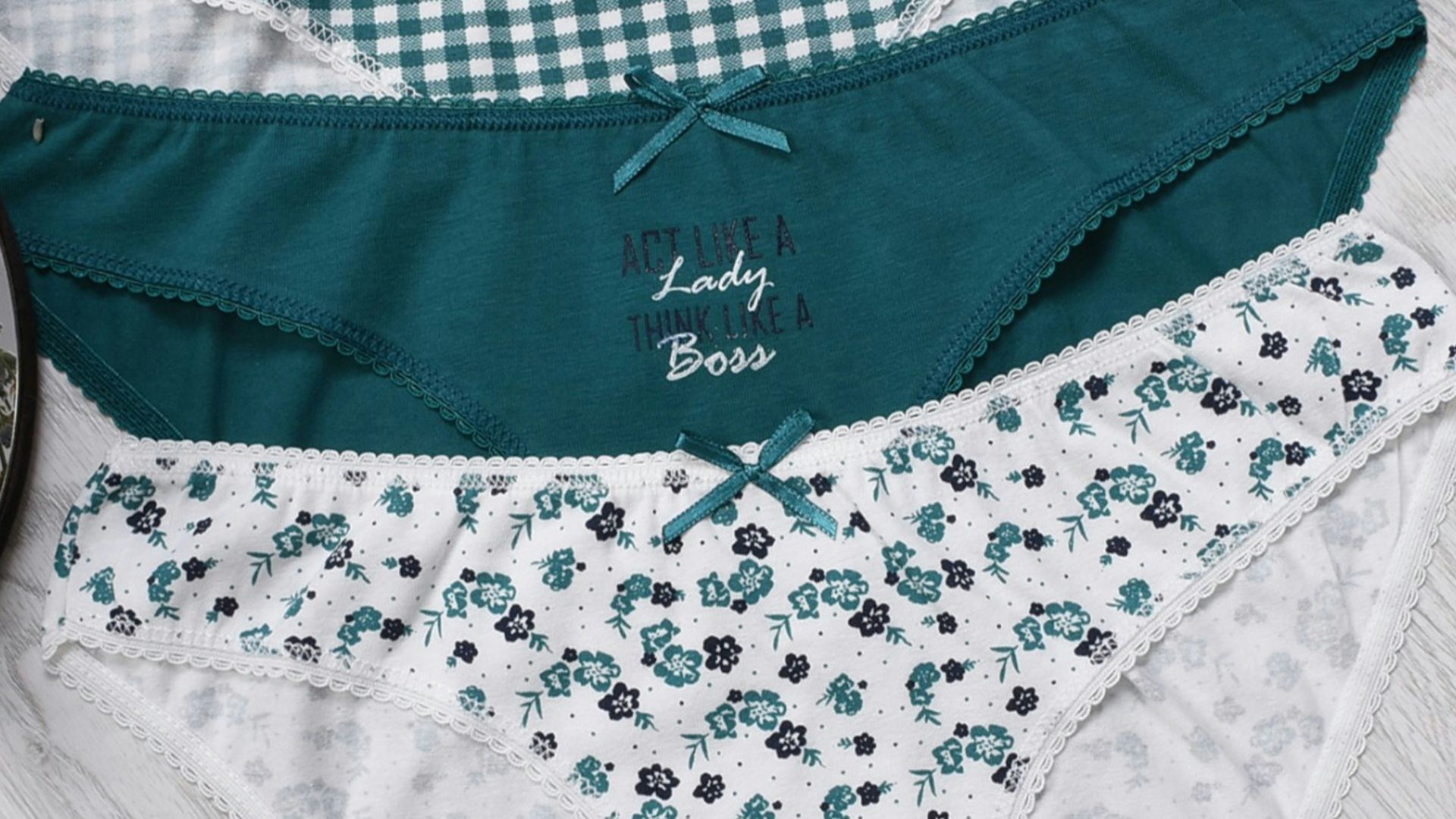 three women's underwear on a white table