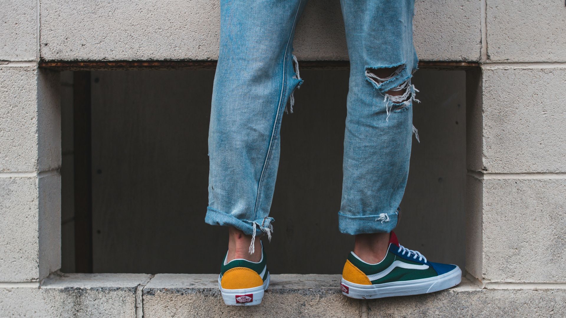 man in pair of green-and-white low-top vans