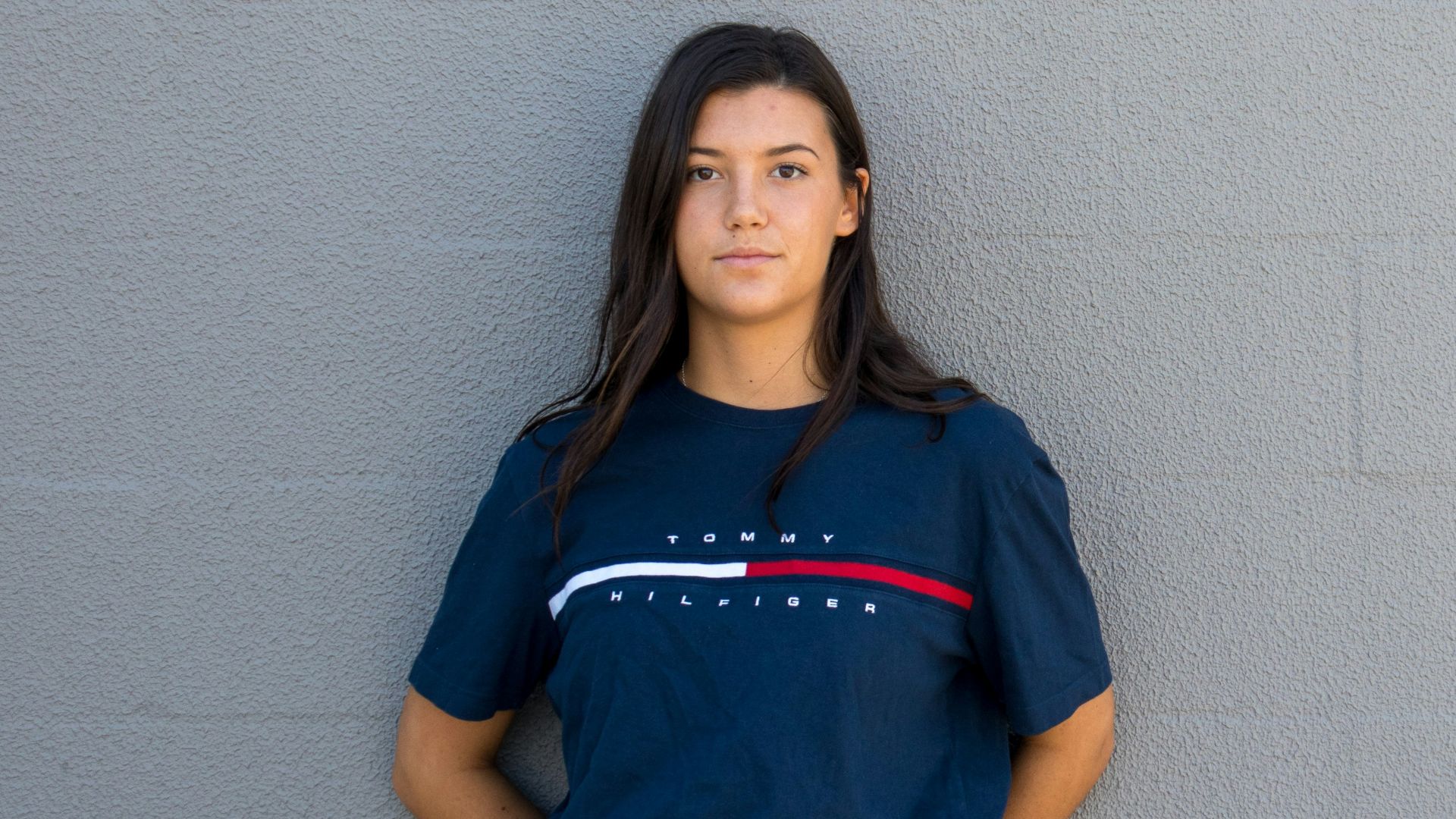 woman standing while leaning on wall