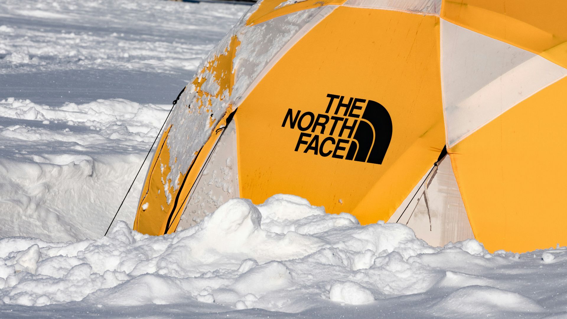 yellow tent on snow covered ground during daytime
