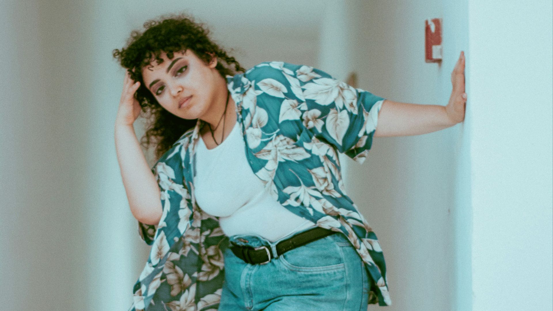 woman holding white concrete wall