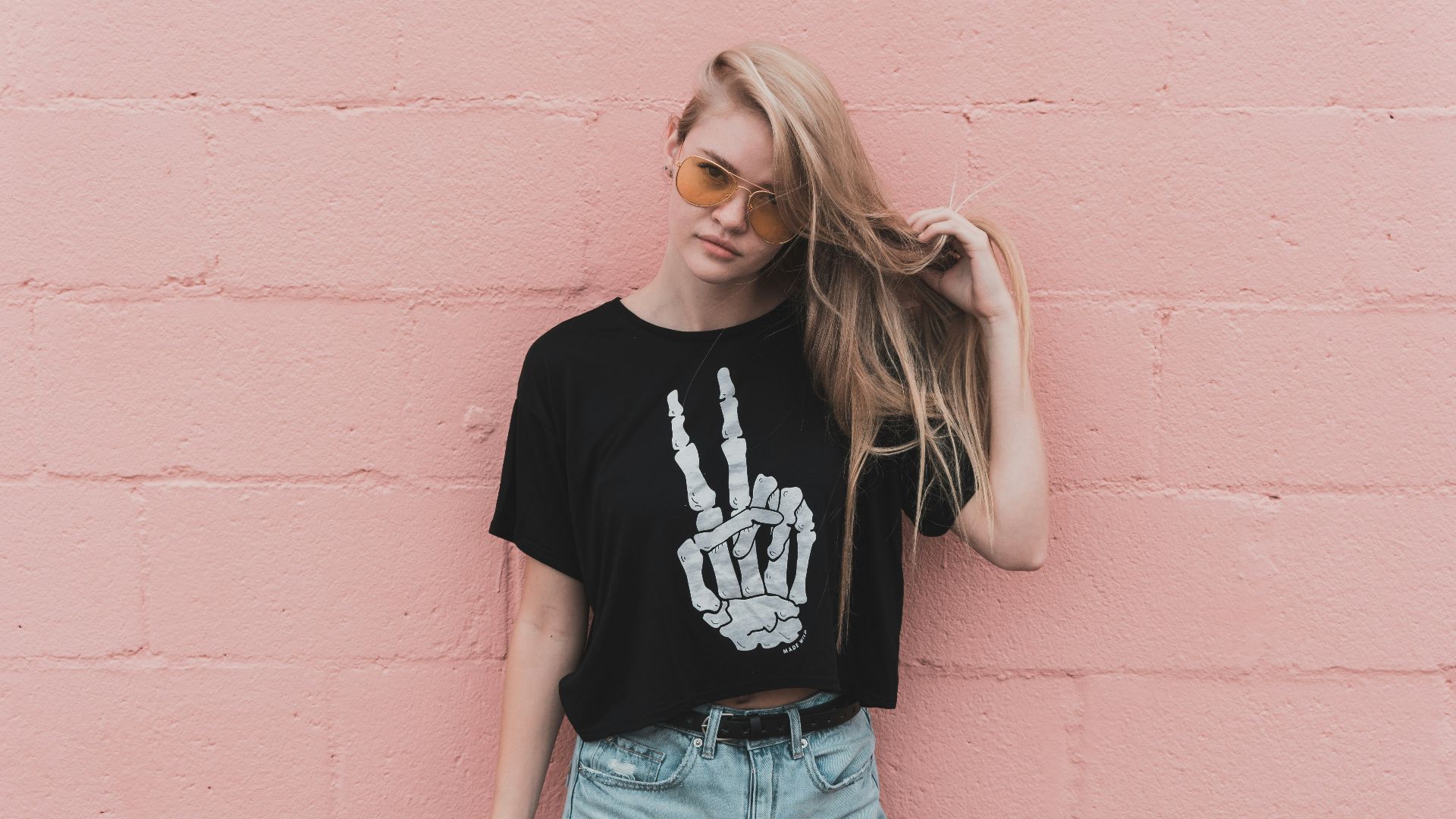 woman standing near pink concrete wall during daytime