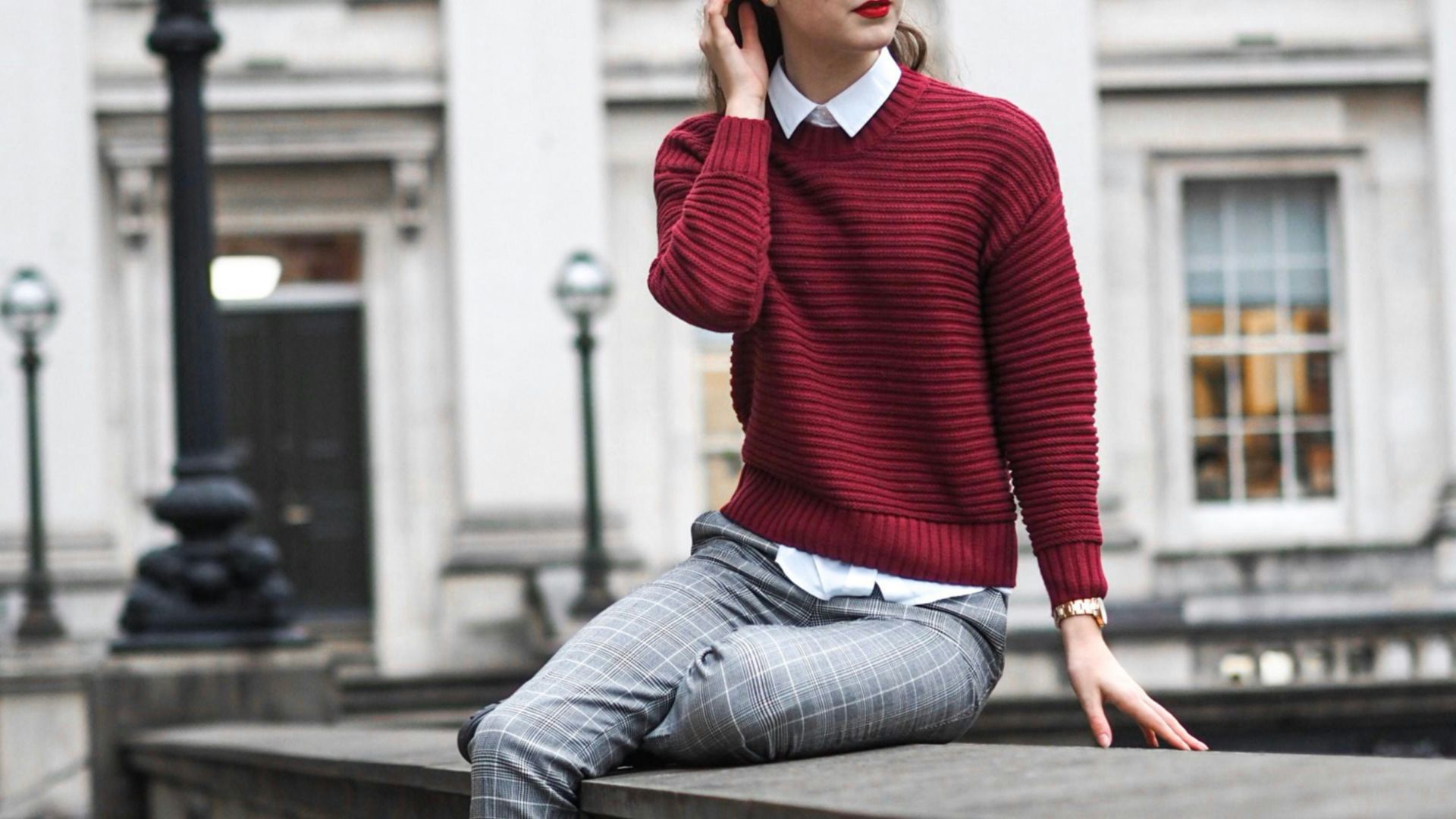 woman sitting on barricade