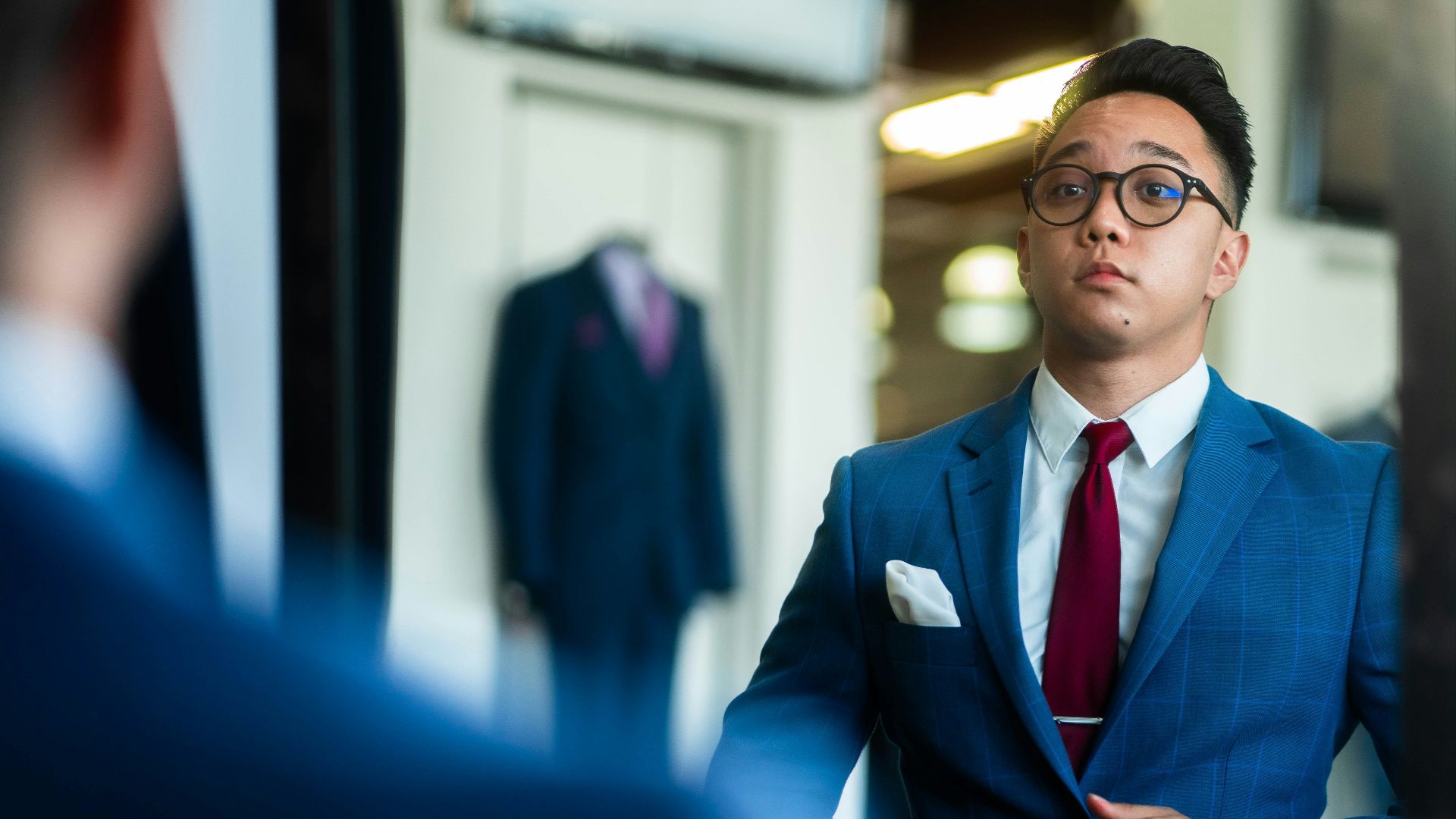 man in black suit wearing eyeglasses