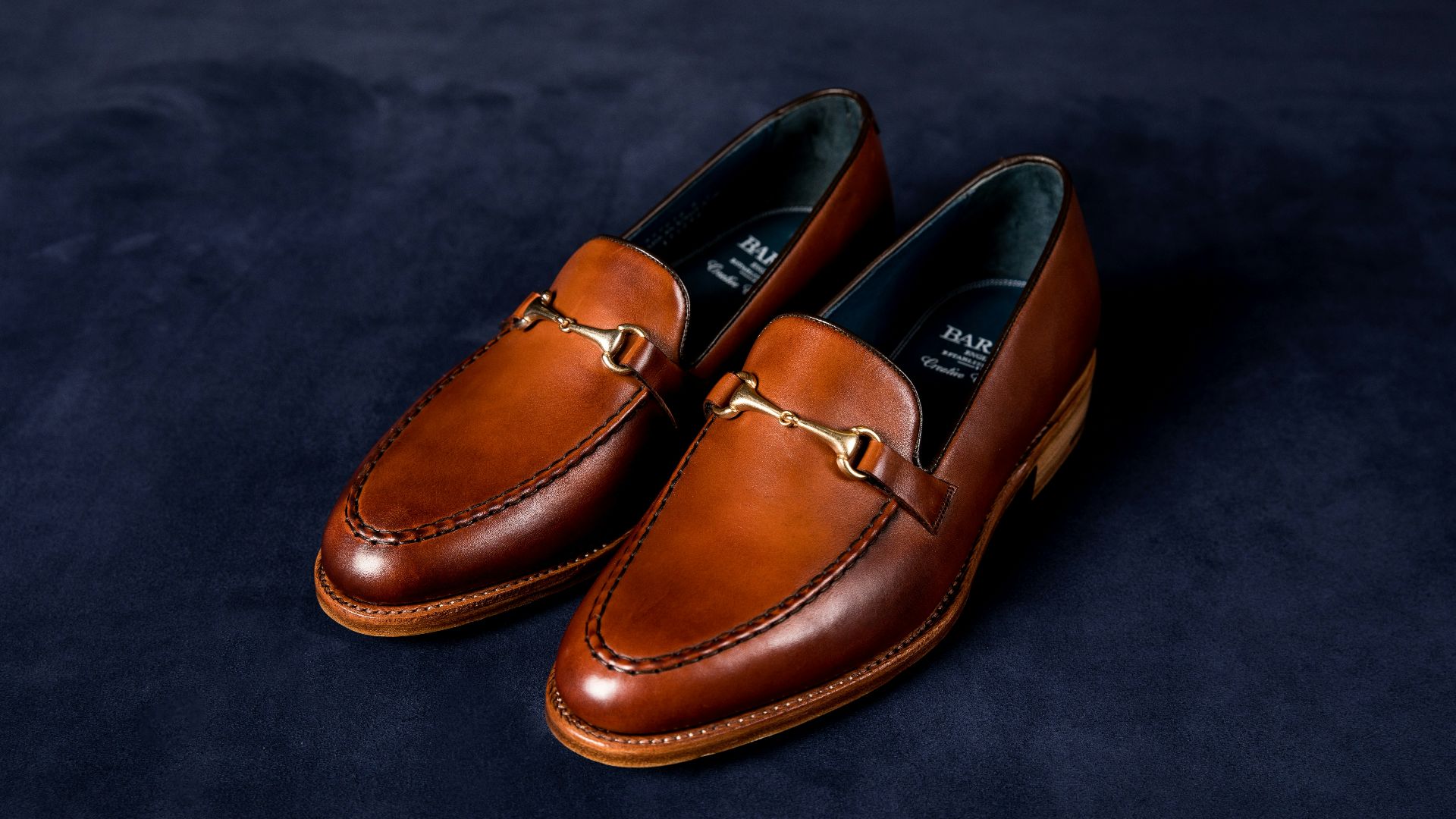 brown leather loafers on blue textile