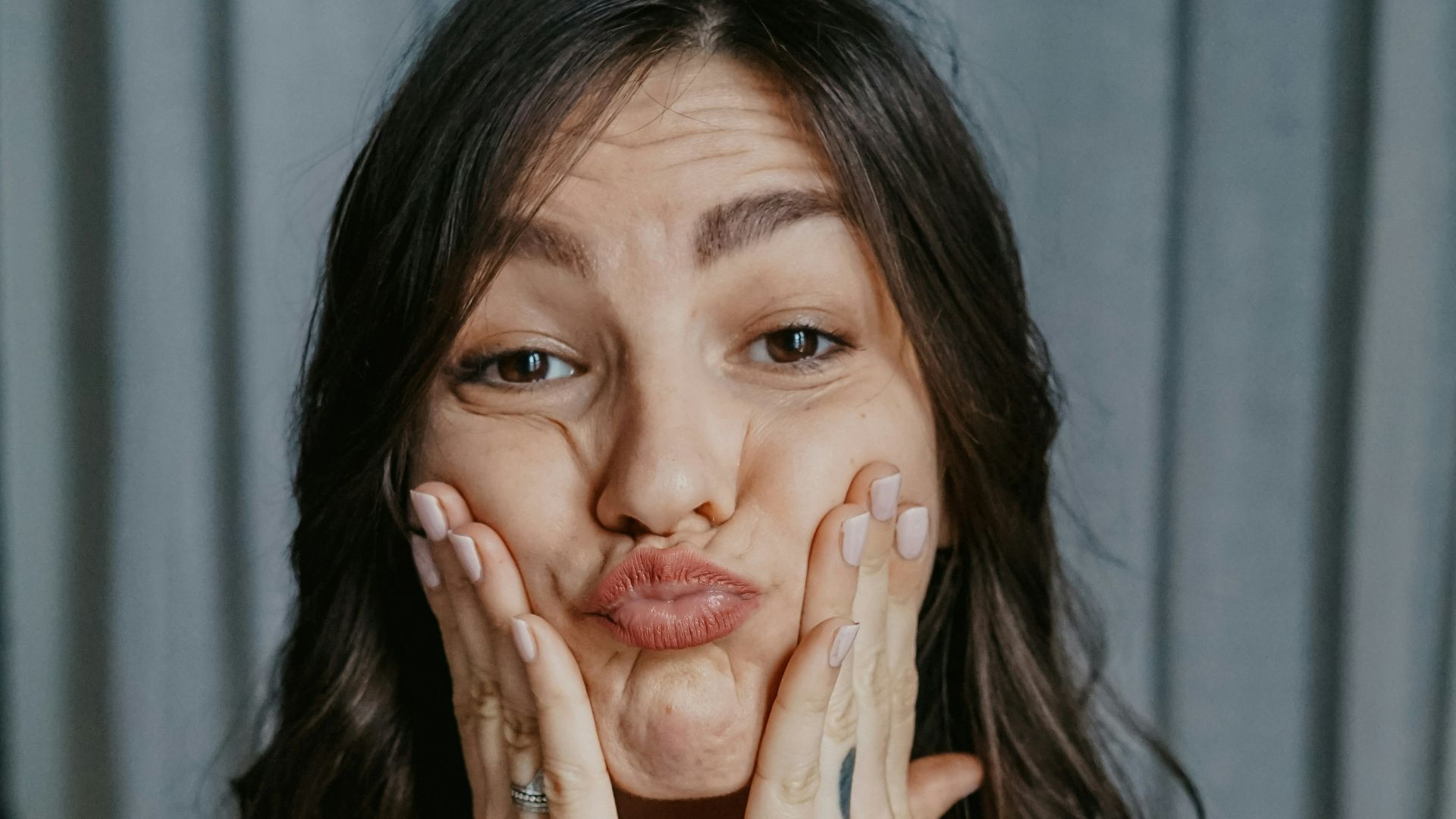 woman in black long sleeve shirt with black tattoo on her left hand