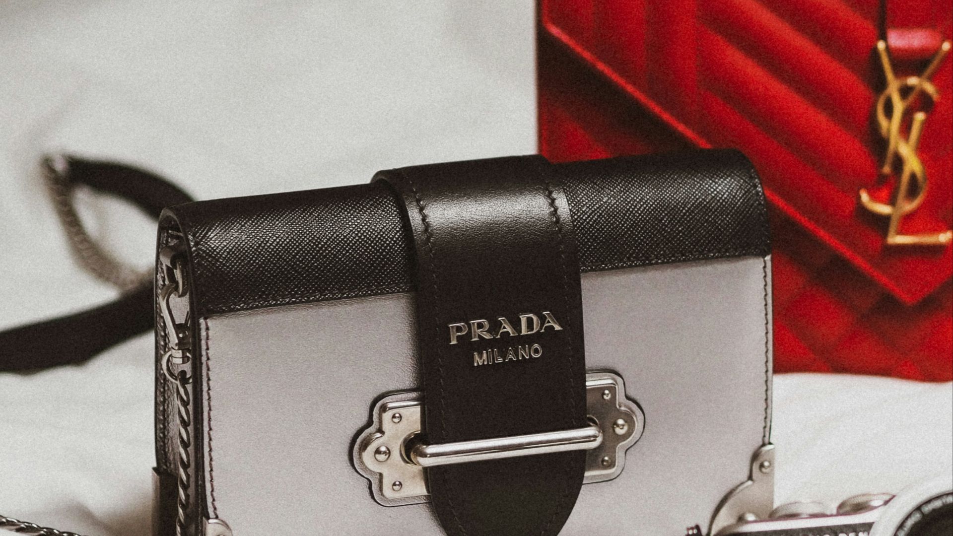 black and silver camera on white textile