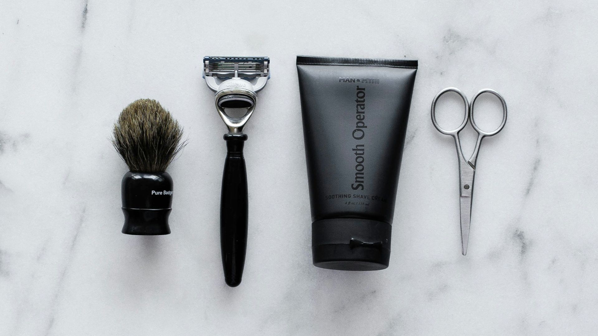 black and silver hair brush beside black soft tube