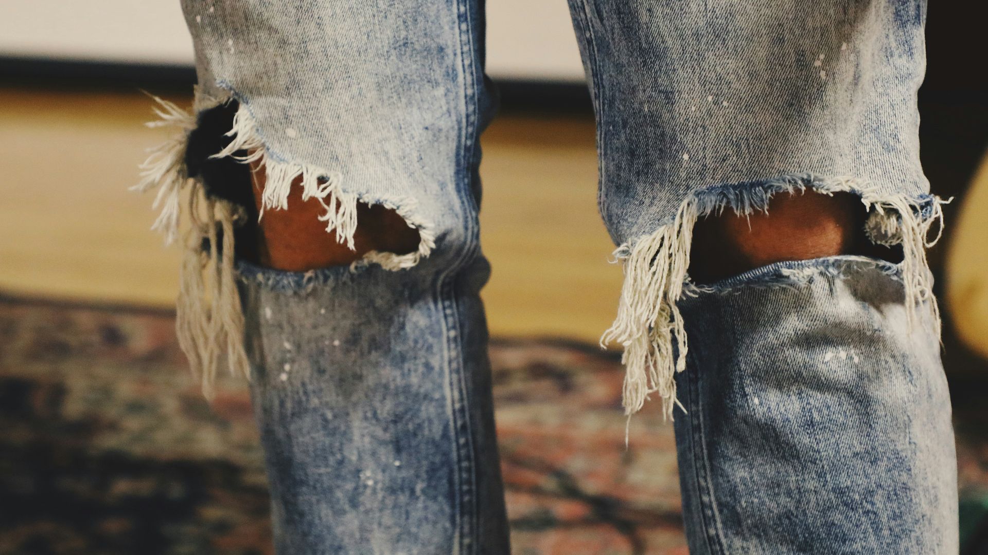 person standing on floral area rug