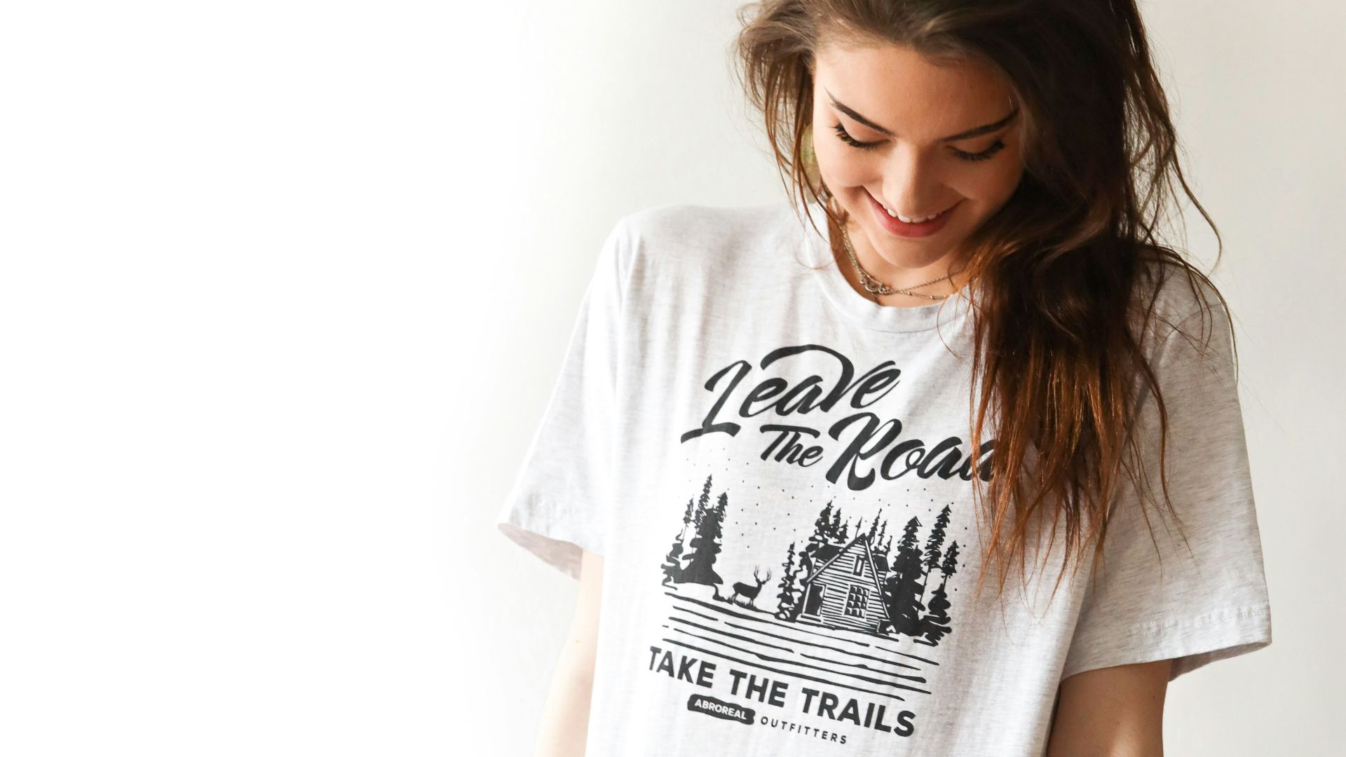 smiling woman in black and white print t-shirt