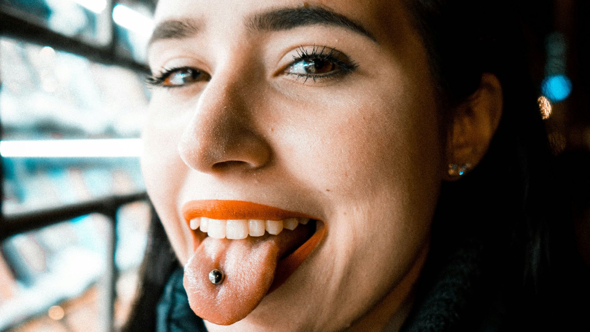 woman showing tongue with piercing