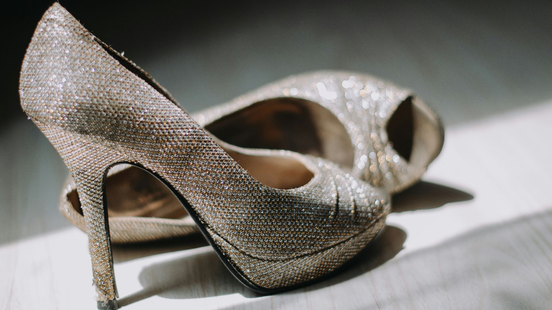 close up photography of pair of silver leather platform stilettos