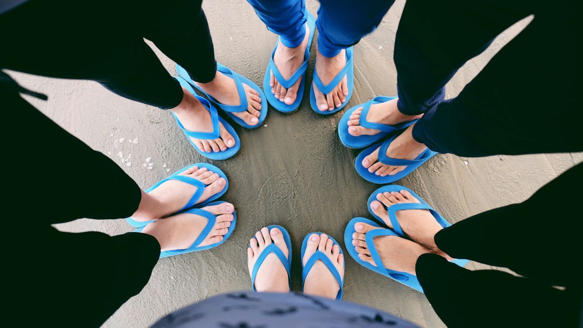 six people wearing blue flip-flops