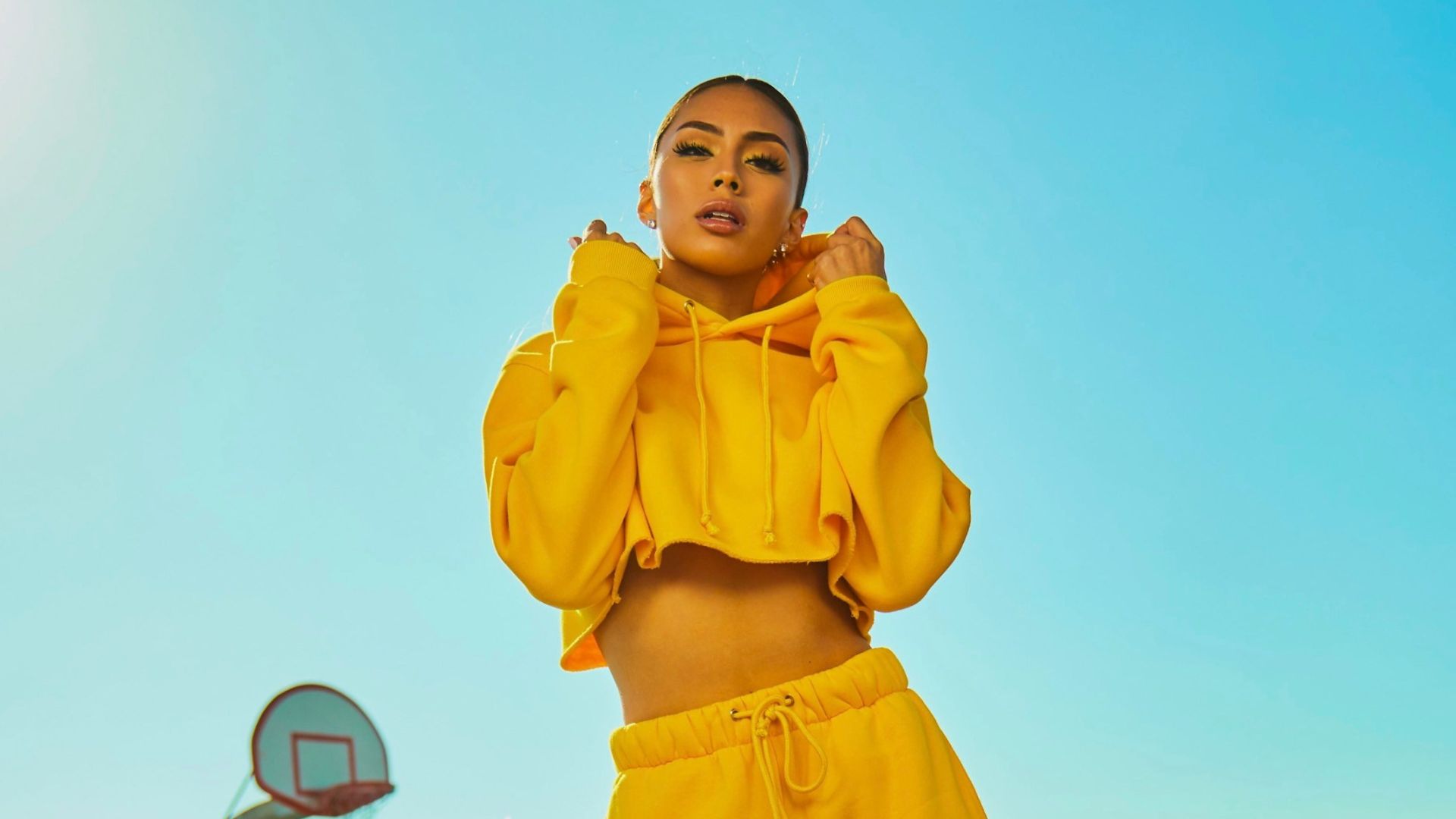 woman in yellow tracksuit standing on basketball court side
