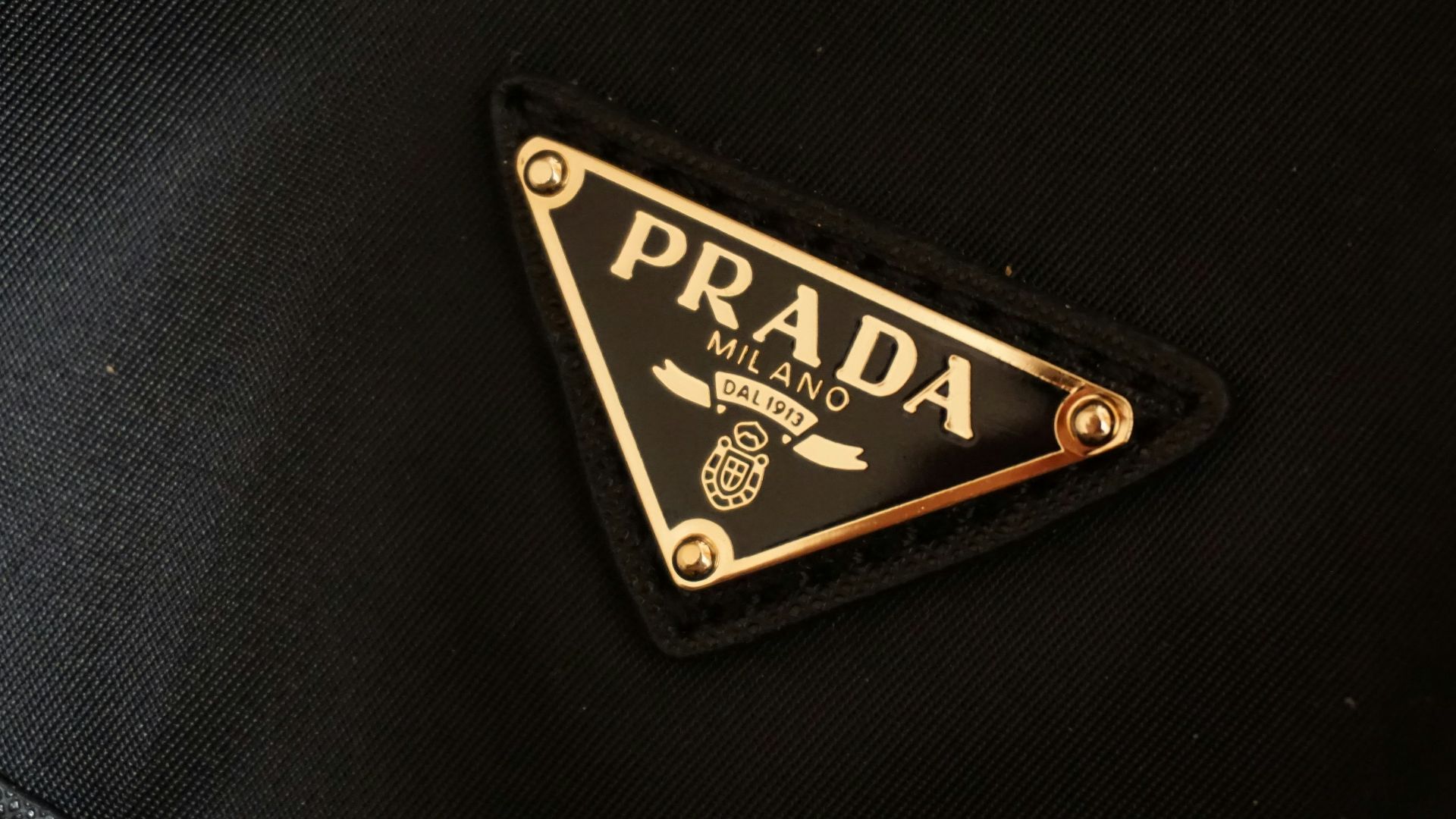 a prada logo on a black jacket
