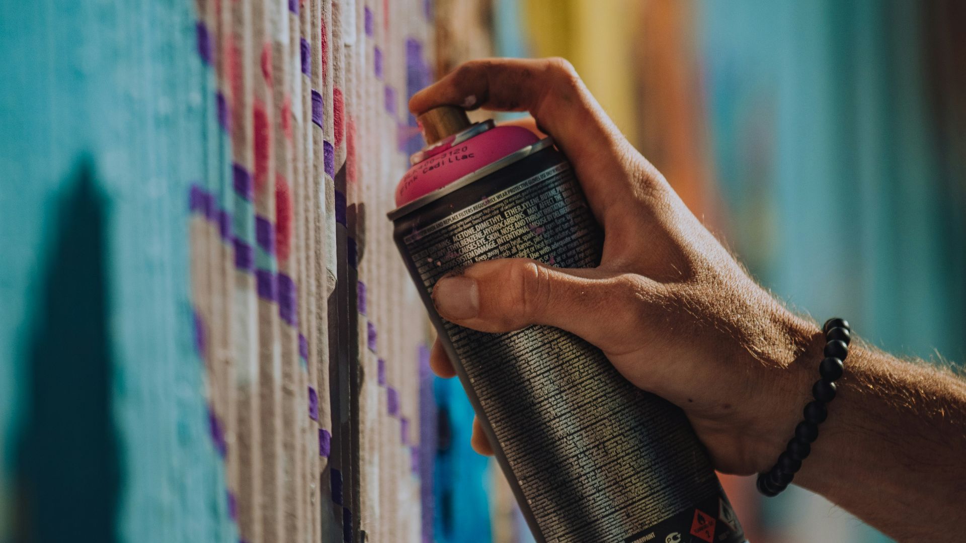 person holding black and red can