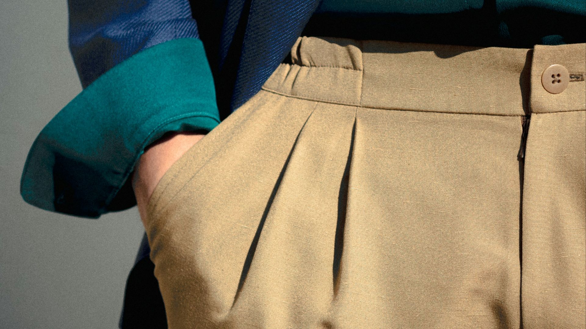 person in blue long sleeve shirt and beige skirt