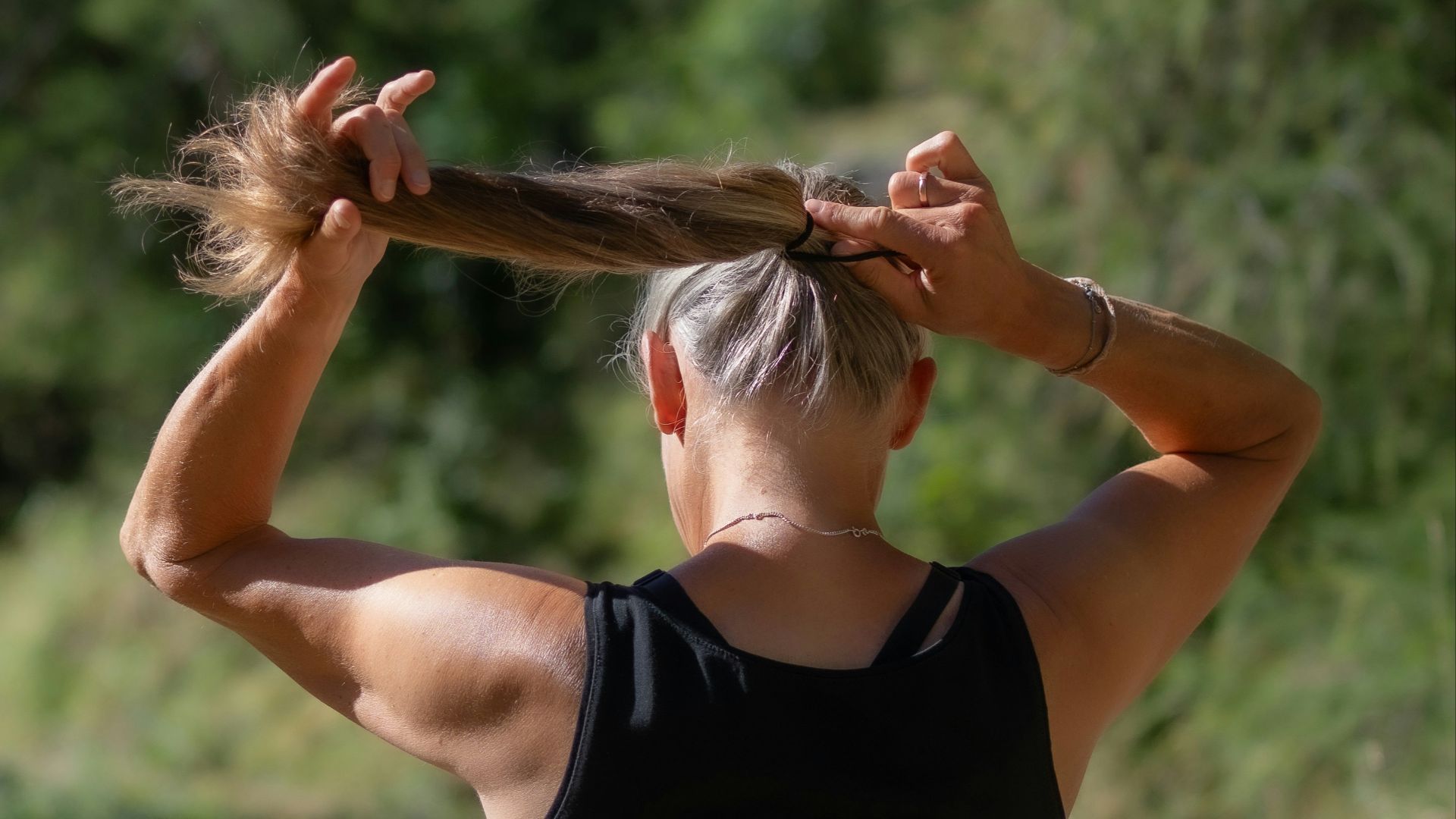 a woman with her hair in a ponytail