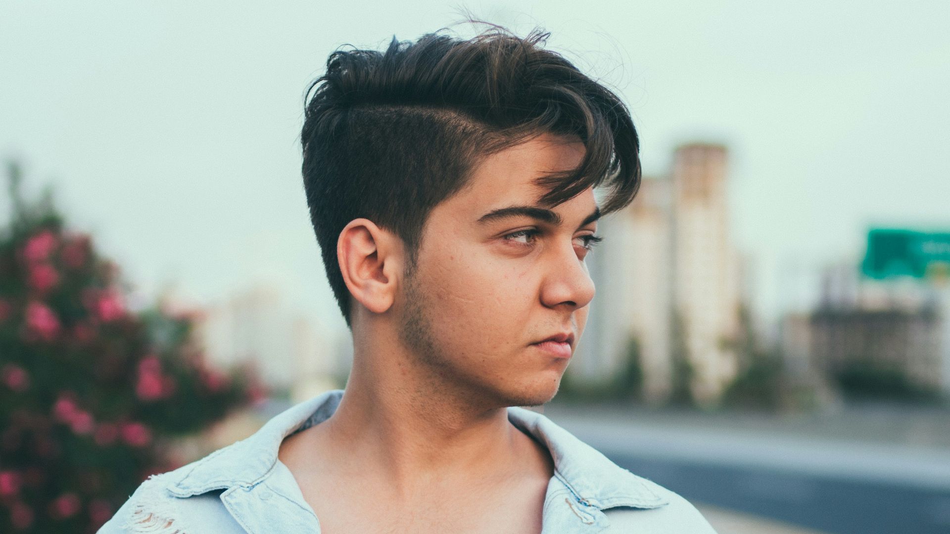 man standing wearing blue denim jacket