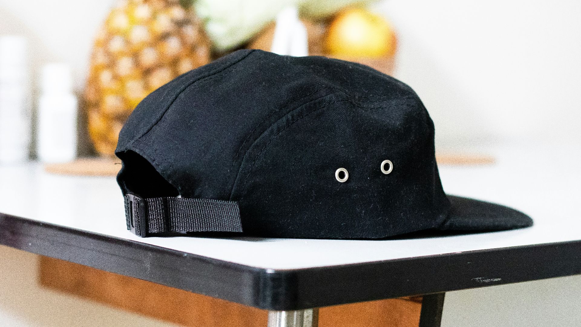 black and white cap on white table