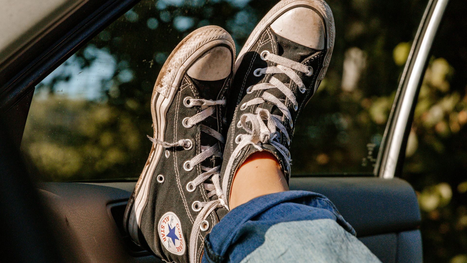 person in blue denim jeans and brown and white hiking shoes