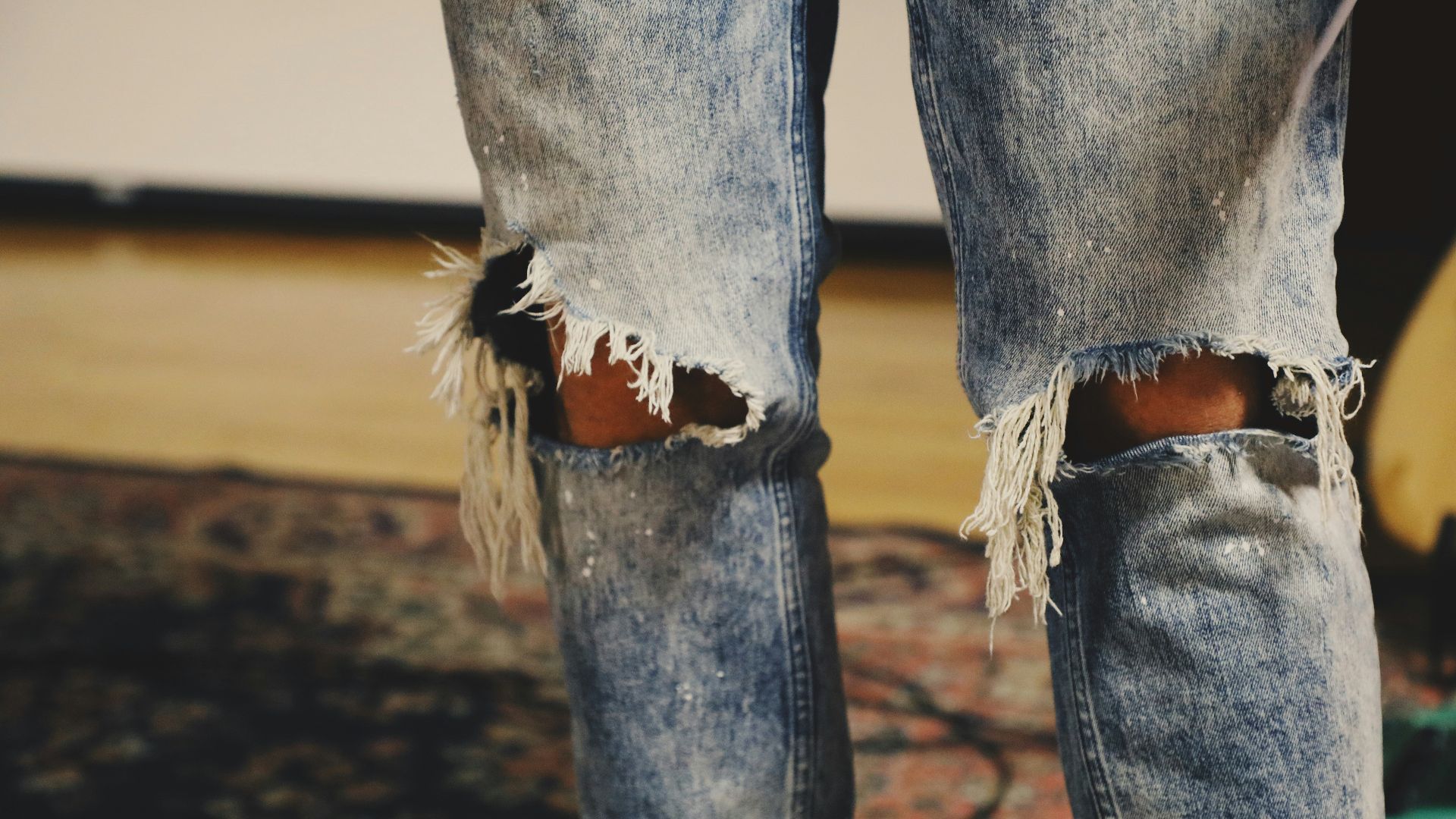 person standing on floral area rug