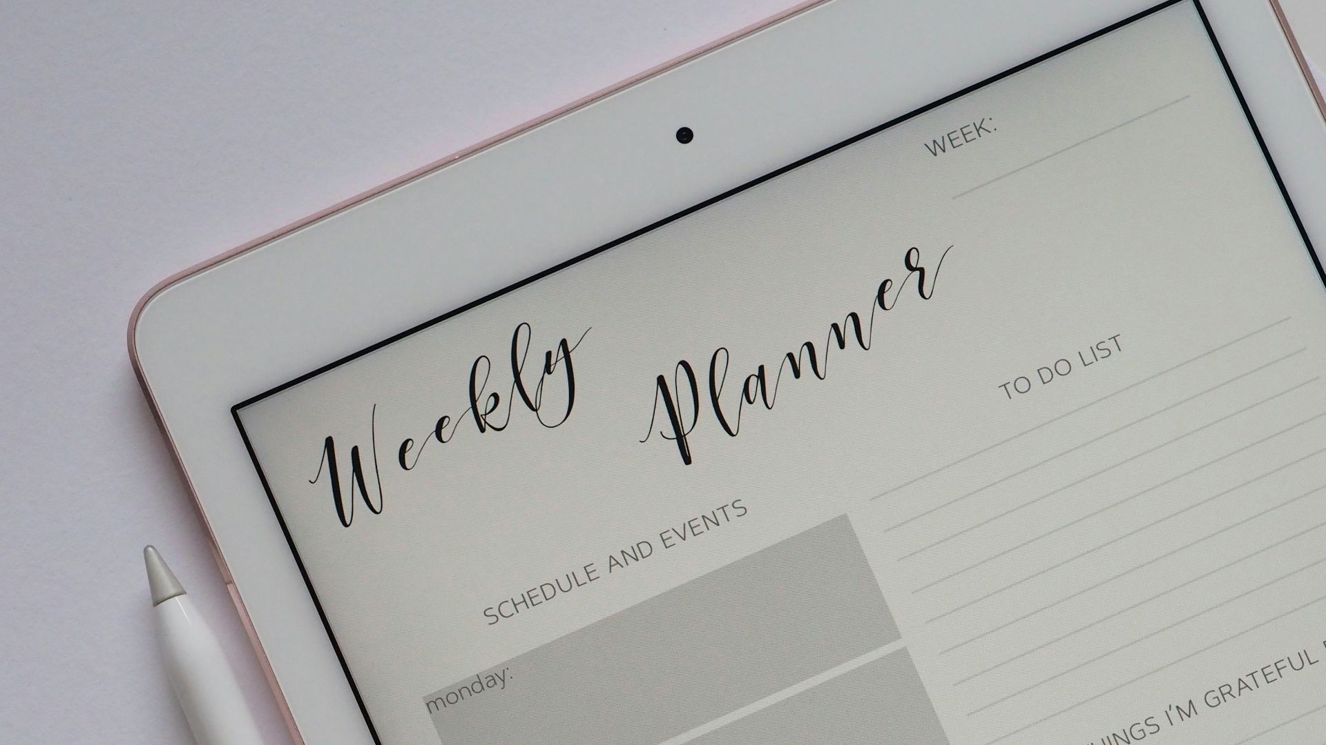 flat lay photography of turned-on silver iPad beside Apple Pencil