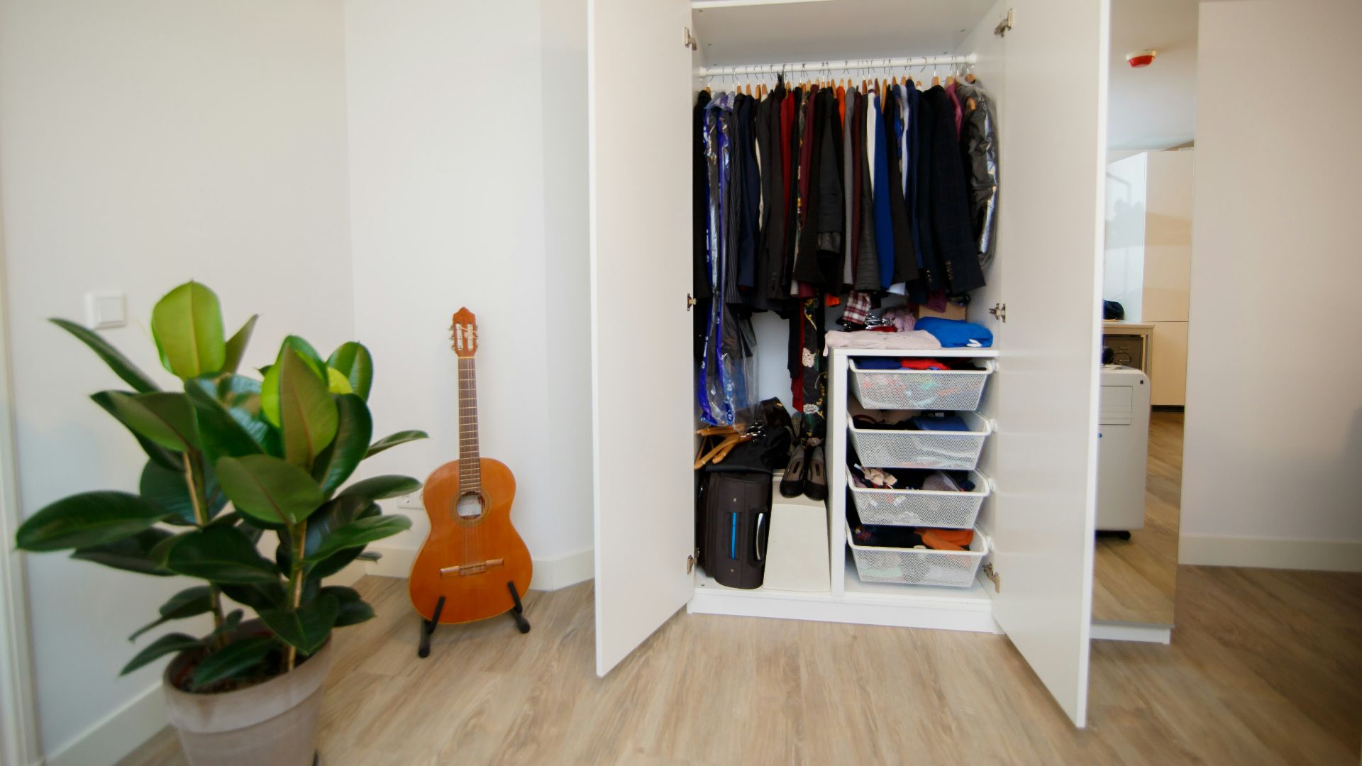 hanged assorted-colored clothes in white cabinet