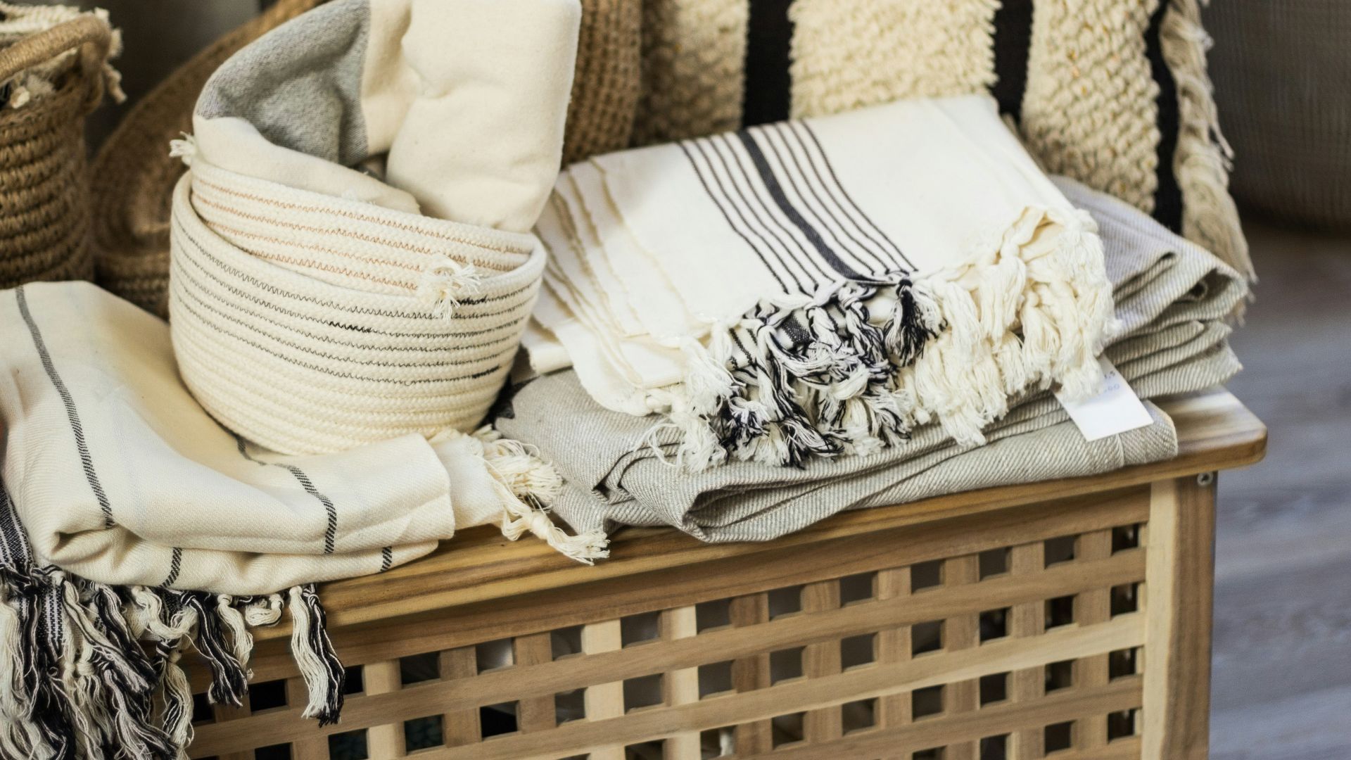 white and black floral textile on brown woven armchair